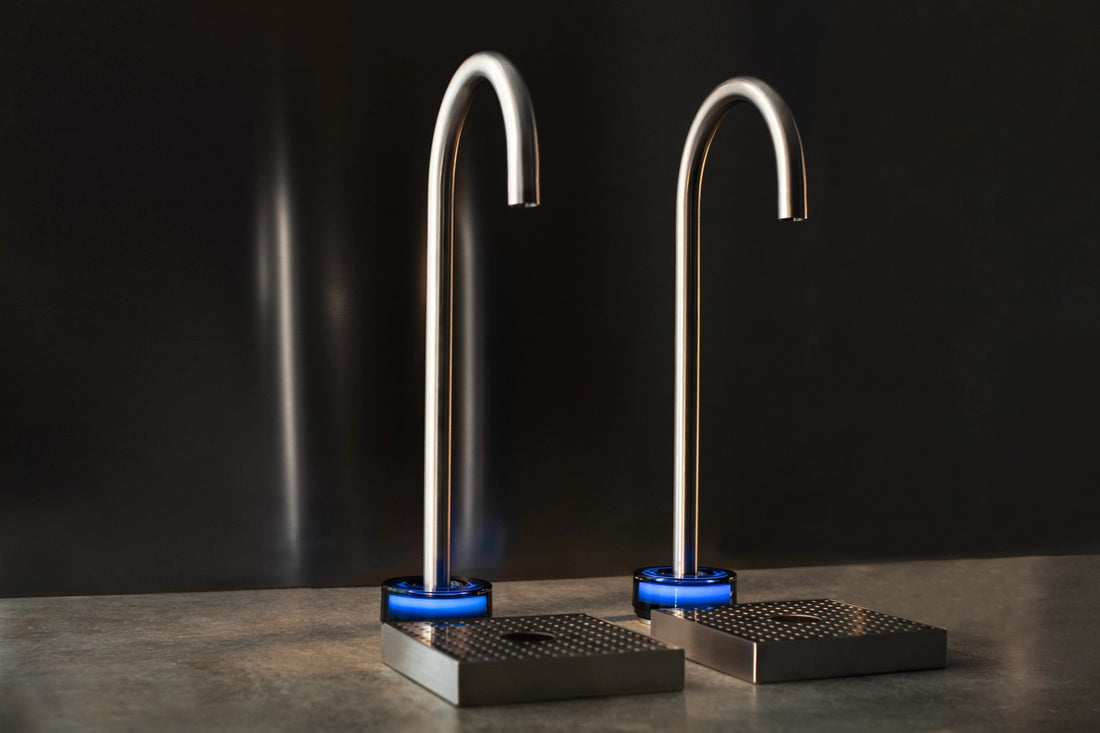 Two Bluewater Restaurant Station taps on a dark counter